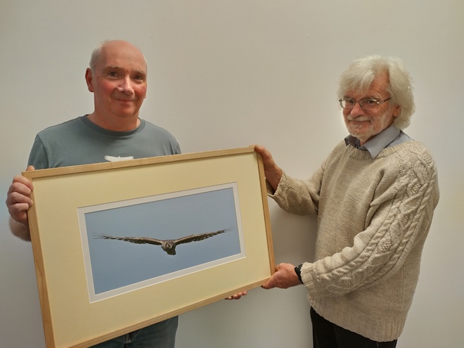 David Stroud handing Andrew Stevenson a framed photo of a hen harrier, taken by Ian Poxton, as a gift from SRMG to say thank you for all of the time and effort he has given to SRMS as Chairperson.